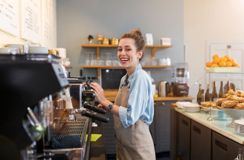 Smiling barista working at a coffee shop